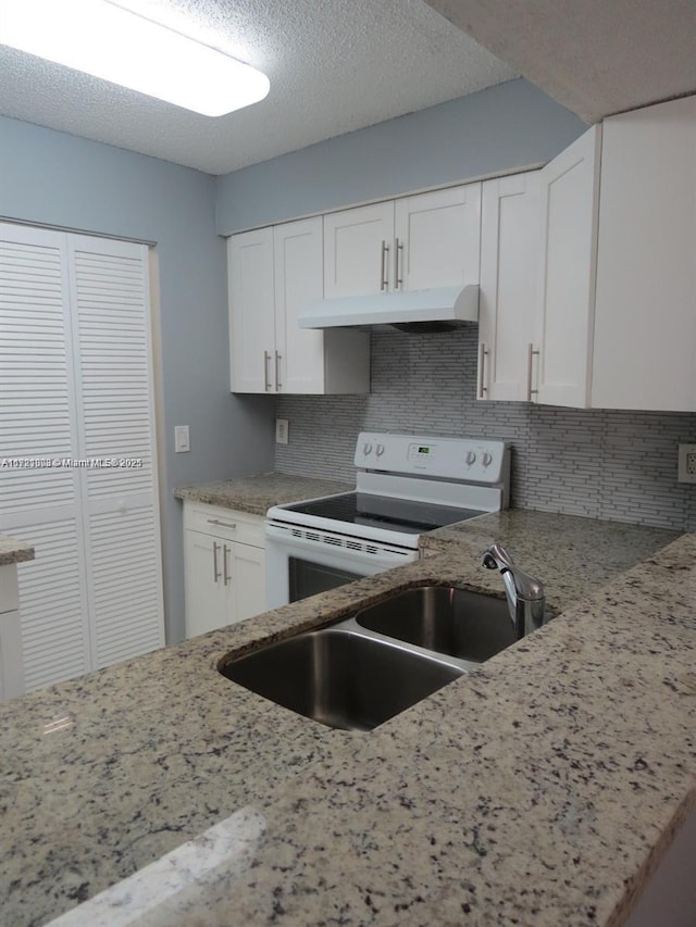 kitchen with electric range, light stone counters, white cabinetry, and tasteful backsplash