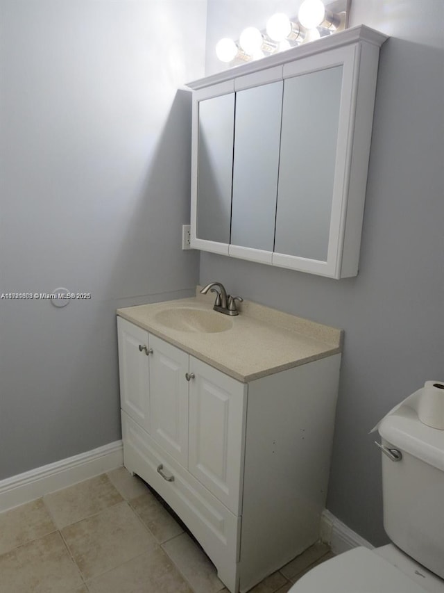 bathroom with tile patterned floors, vanity, and toilet