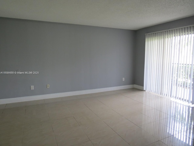 unfurnished room featuring light tile patterned floors