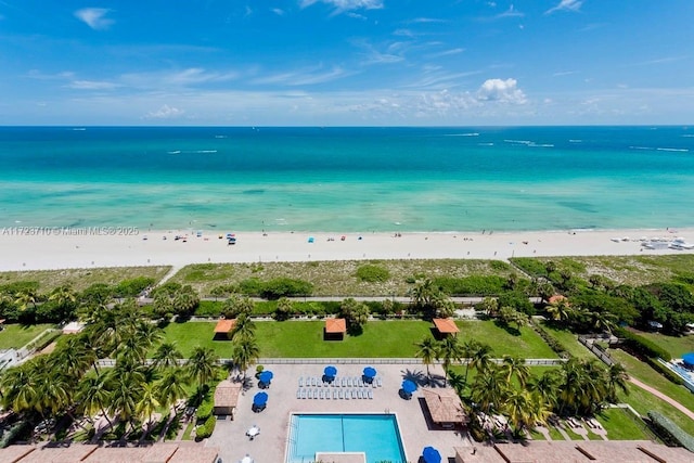 birds eye view of property with a beach view and a water view