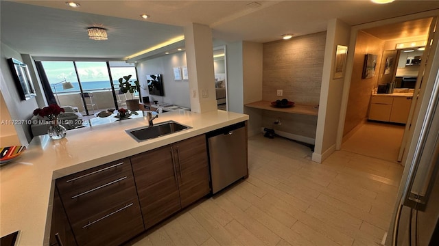 kitchen featuring floor to ceiling windows, dishwasher, sink, tasteful backsplash, and dark brown cabinetry