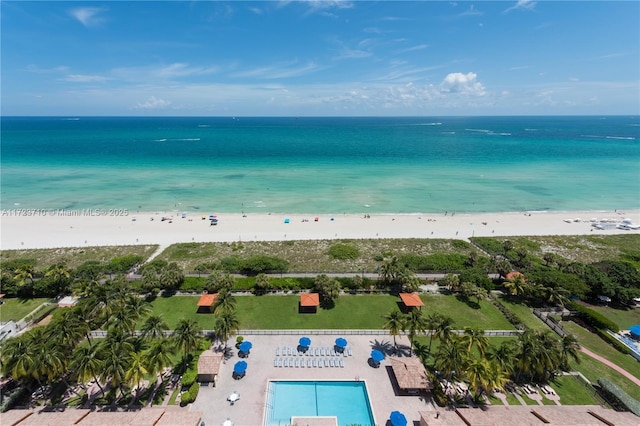 birds eye view of property featuring a beach view and a water view