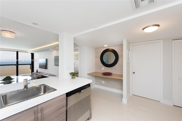 kitchen featuring dishwasher, sink, and floor to ceiling windows