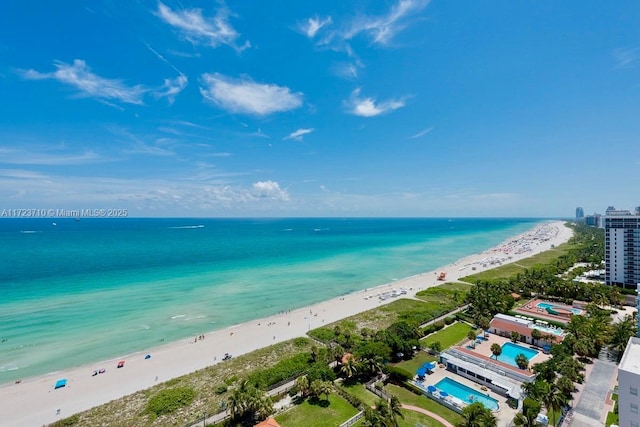 drone / aerial view with a water view and a beach view