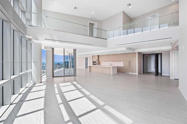 unfurnished living room with a high ceiling