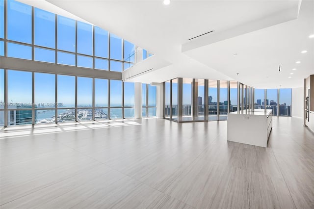 unfurnished living room with a water view and a healthy amount of sunlight