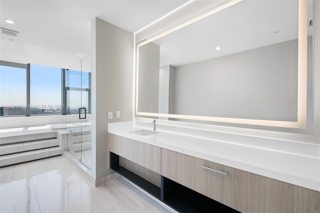 bathroom with vanity, an enclosed shower, and a wall of windows