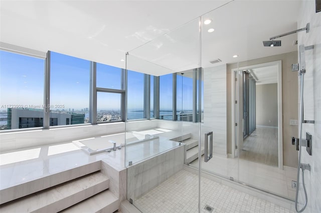 bathroom featuring tile patterned floors, a wealth of natural light, and shower with separate bathtub