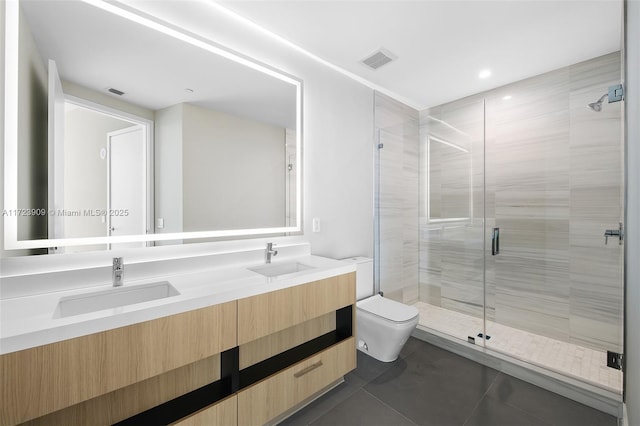 bathroom featuring tile patterned flooring, vanity, a shower with shower door, and toilet