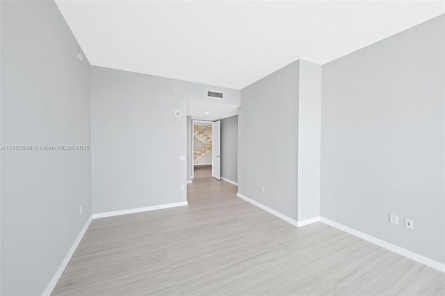 empty room with light hardwood / wood-style flooring