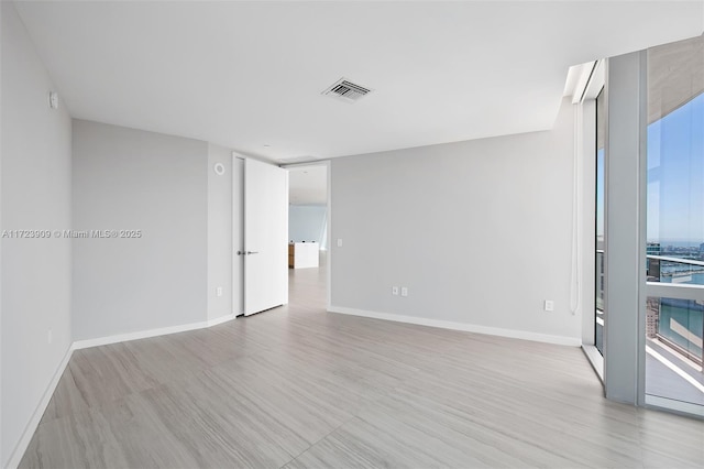 spare room with light wood-type flooring