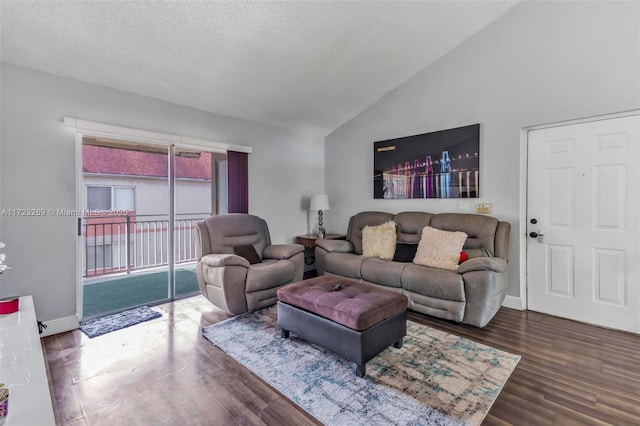 living room featuring dark hardwood / wood-style flooring, a textured ceiling, and vaulted ceiling