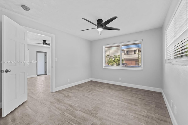 empty room featuring ceiling fan and light hardwood / wood-style flooring