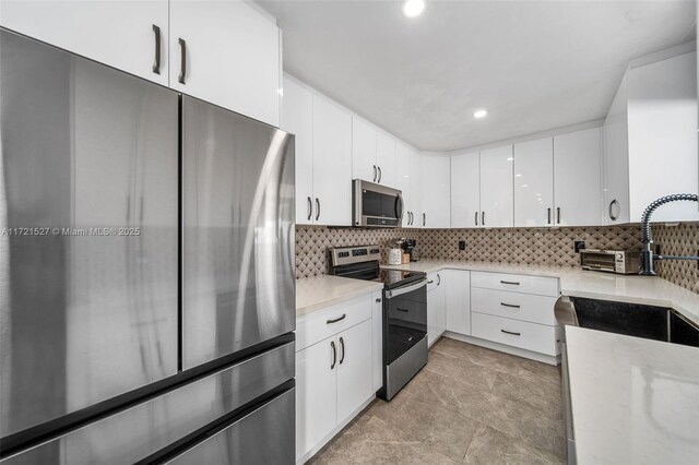 kitchen featuring kitchen peninsula, electric panel, decorative backsplash, white cabinetry, and ceiling fan