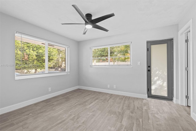 empty room with ceiling fan and light wood-type flooring