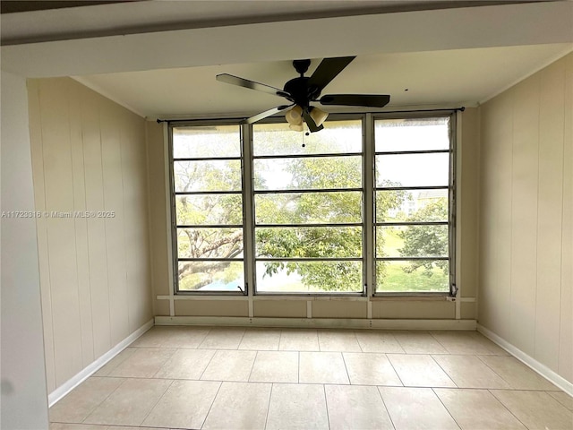 tiled spare room with a wealth of natural light and ceiling fan