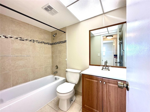 full bathroom featuring tile patterned floors, vanity, toilet, and tiled shower / bath