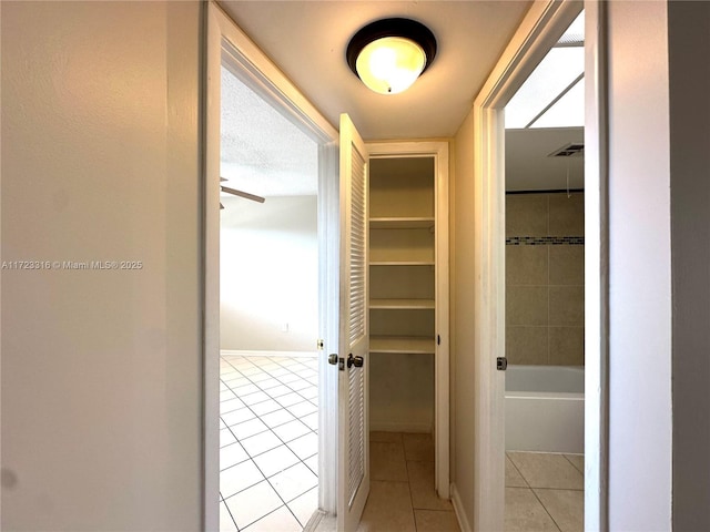 corridor with light tile patterned floors