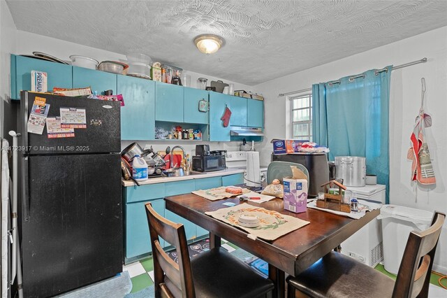 dining space featuring a textured ceiling and sink