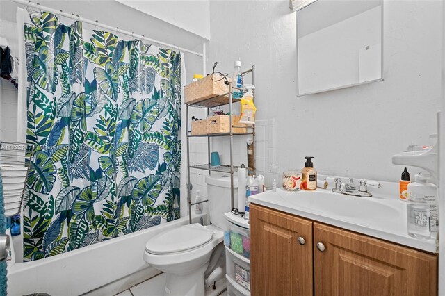 full bathroom featuring shower / bathtub combination with curtain, tile patterned floors, vanity, and toilet