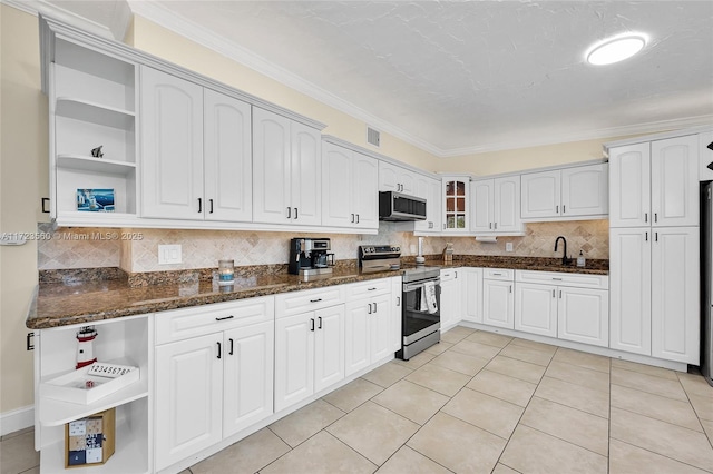 kitchen featuring decorative backsplash, dark stone countertops, ornamental molding, appliances with stainless steel finishes, and white cabinetry