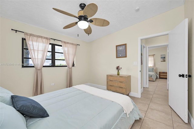 tiled bedroom with ceiling fan