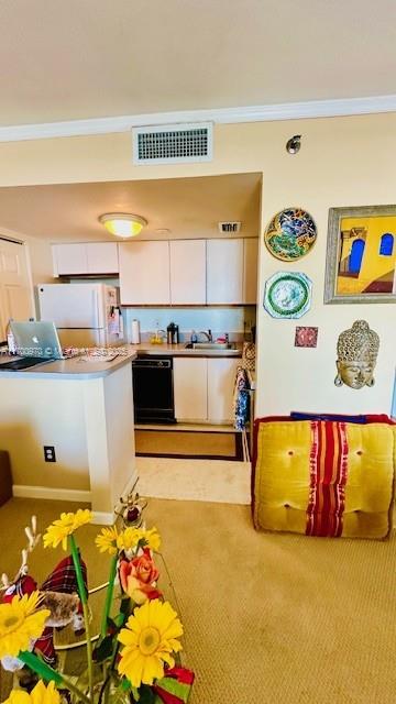 rec room with sink and ornamental molding