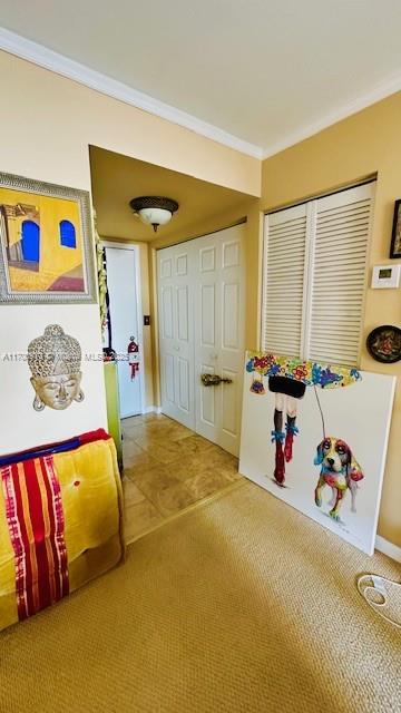 game room with carpet floors and ornamental molding