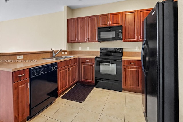 kitchen with light tile patterned floors, sink, and black appliances