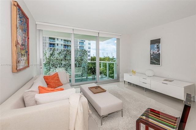 tiled living room featuring floor to ceiling windows