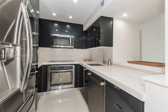 kitchen featuring light tile patterned floors, sink, and appliances with stainless steel finishes