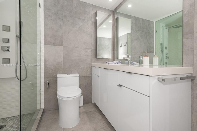 bathroom with vanity, an enclosed shower, tile walls, and toilet