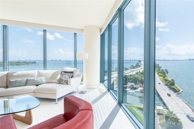 living room with a water view and expansive windows