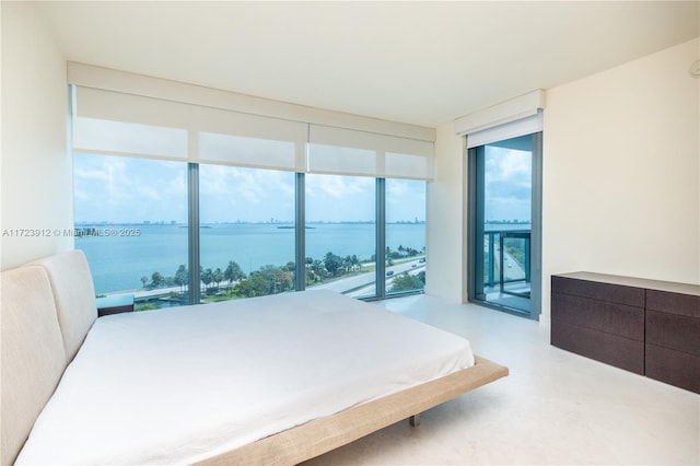 bedroom with a water view and access to outside