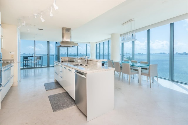 kitchen with decorative light fixtures, dishwasher, a center island with sink, white cabinets, and island range hood