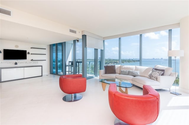 living room featuring expansive windows and a water view