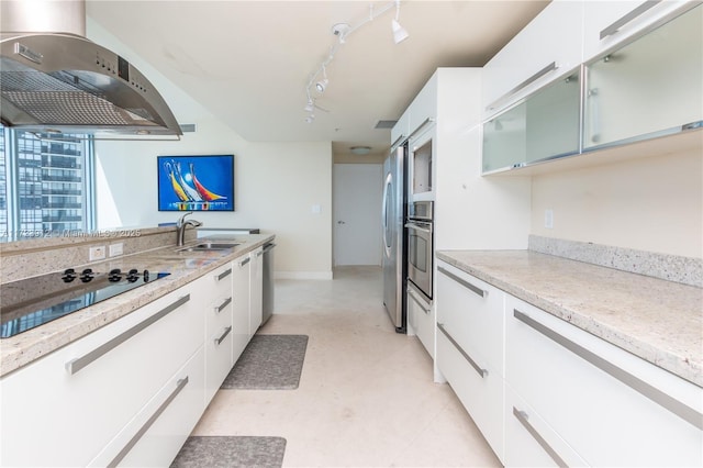 kitchen with sink, white cabinets, stainless steel appliances, and exhaust hood