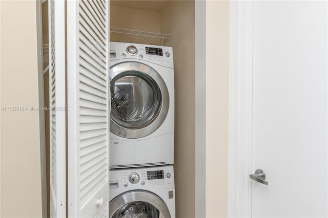 washroom with stacked washer / drying machine