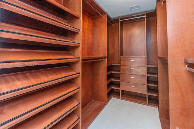 spacious closet featuring light tile patterned floors