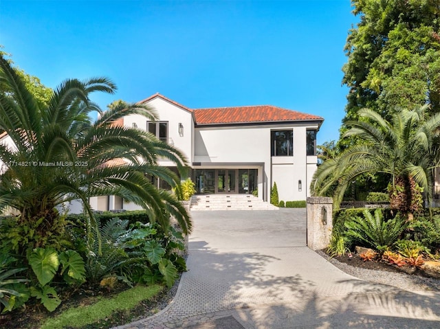 mediterranean / spanish-style home with french doors