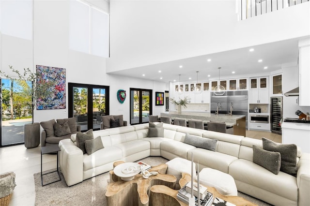 living room featuring french doors and a towering ceiling