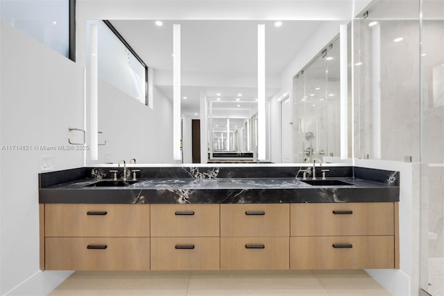 bathroom with vanity and a shower with shower door