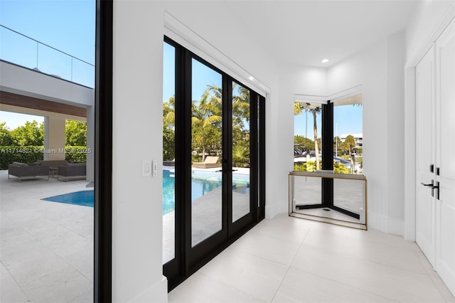 doorway to outside featuring light tile patterned floors and french doors