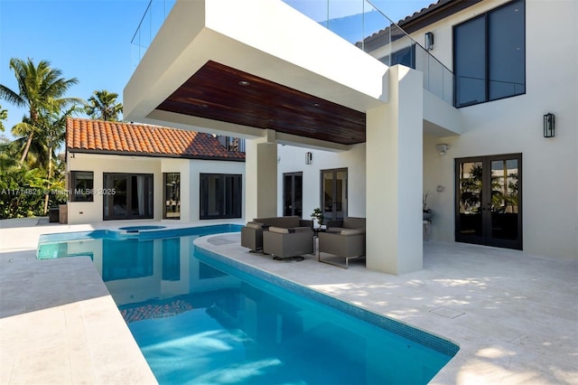 view of pool featuring an in ground hot tub, a patio, and french doors