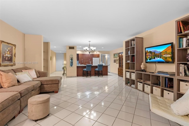 tiled living room with built in shelves and a chandelier