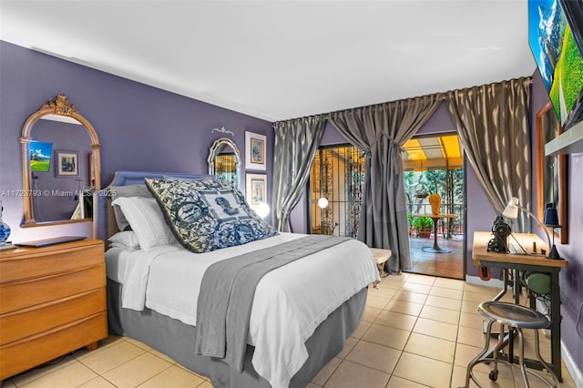 bedroom with access to exterior and light tile patterned flooring