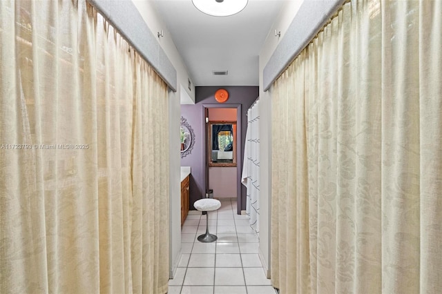 corridor with light tile patterned floors