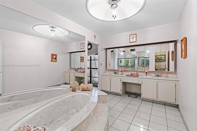 bathroom with tile patterned flooring, vanity, and tiled bath