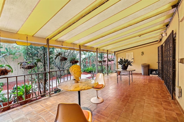 sunroom / solarium featuring lofted ceiling