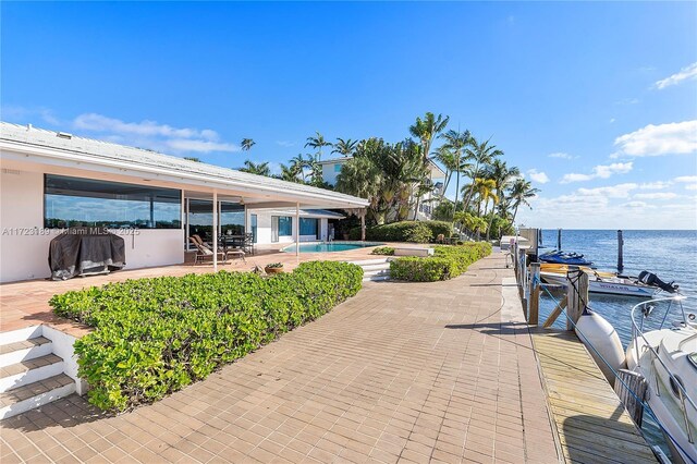 view of patio / terrace featuring a dock and a water view